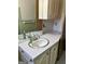 This bathroom includes a vintage vanity, mirror, and plentiful storage space at 2334 Connally Dr, East Point, GA 30344