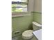 This vintage bathroom has a window and neutral-colored floral wallpaper at 2334 Connally Dr, East Point, GA 30344