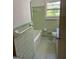 Well-maintained bathroom with vintage green tiling, featuring a tub, toilet, and vanity with ample storage at 2334 Connally Dr, East Point, GA 30344