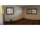 A bright bedroom featuring two shuttered windows and neutral walls at 2334 Connally Dr, East Point, GA 30344