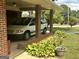 Attached carport offers convenient covered parking, surrounded by lush greenery and garden accents at 2334 Connally Dr, East Point, GA 30344