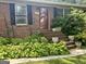 Charming brick home with a welcoming front door, black shutters, and lush landscaping for added curb appeal at 2334 Connally Dr, East Point, GA 30344