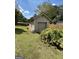 View of a detached garage with beige siding, a roll-up door, and a regular door at 2334 Connally Dr, East Point, GA 30344