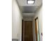 Hallway with white walls, wood trim doors, light fixture and vent at the top at 2334 Connally Dr, East Point, GA 30344
