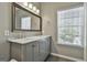 Bathroom featuring double sinks with modern fixtures and a large mirror over the marble countertop at 508 Las Brasis Ct, Peachtree City, GA 30269