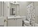 Bathroom with a single sink and vanity, along with a toilet and shower with curtain at 508 Las Brasis Ct, Peachtree City, GA 30269