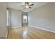 Spacious bedroom features hardwood floors, a ceiling fan, and natural light from the window at 508 Las Brasis Ct, Peachtree City, GA 30269
