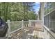 Outdoor deck with white railings, offering a tranquil view of the surrounding trees at 508 Las Brasis Ct, Peachtree City, GA 30269