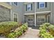 Inviting entryway showcasing a well-maintained walkway, landscaped bushes and gray siding at 508 Las Brasis Ct, Peachtree City, GA 30269