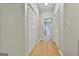 Hallway featuring hardwood floors, closet space, and access to rooms at 508 Las Brasis Ct, Peachtree City, GA 30269