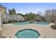 A hot tub and view of the community pool with trees in the background at 508 Las Brasis Ct, Peachtree City, GA 30269