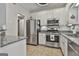 Modern kitchen with stainless steel appliances, granite countertops, and ample cabinet space at 508 Las Brasis Ct, Peachtree City, GA 30269