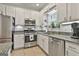 Well-equipped kitchen with stainless steel appliances, granite countertops, and tile flooring at 508 Las Brasis Ct, Peachtree City, GA 30269