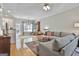 Spacious living room with hardwood floors, a ceiling fan, natural light, and comfortable seating at 508 Las Brasis Ct, Peachtree City, GA 30269