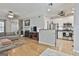 Spacious living room open to the kitchen, featuring hardwood floors and a fireplace at 508 Las Brasis Ct, Peachtree City, GA 30269