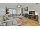 Spacious living room with hardwood floors, a fireplace, natural light, and comfortable seating at 508 Las Brasis Ct, Peachtree City, GA 30269