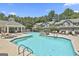Community pool featuring several lounge chairs and a waterfall feature with trees in the background at 508 Las Brasis Ct, Peachtree City, GA 30269