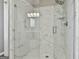 Beautiful tile shower with glass door, rainfall shower head, and built-in shelving at 508 Las Brasis Ct, Peachtree City, GA 30269