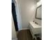 Bright bathroom features a white vanity, a clean aesthetic, and wood-look flooring at 1333 Happy Hill Rd, Carrollton, GA 30116