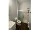 Well-lit bathroom featuring a glass-enclosed shower, toilet, and vanity, offering a functional space at 1333 Happy Hill Rd, Carrollton, GA 30116