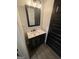 Stylish bathroom featuring a dark vanity, granite countertop, and modern fixtures, showcasing sophistication at 1333 Happy Hill Rd, Carrollton, GA 30116