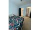 Comfortable bedroom with floral bedding, carpet, closet and bathroom entrances at 1333 Happy Hill Rd, Carrollton, GA 30116