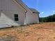 The side exterior of this lovely home features white siding and black gutters at 1333 Happy Hill Rd, Carrollton, GA 30116