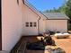 This side exterior features white siding, as well as an ATV and some outdoor equipment at 1333 Happy Hill Rd, Carrollton, GA 30116