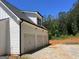 Exterior view of a three car garage with white doors and siding at 1333 Happy Hill Rd, Carrollton, GA 30116