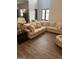 Bright living room featuring a large sectional sofa, wood floors, and natural light, creating a comfortable ambiance at 1333 Happy Hill Rd, Carrollton, GA 30116