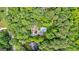 Aerial view capturing a lush landscape featuring a house and pool surrounded by dense foliage at 210 Farr Lake Dr, Tyrone, GA 30290
