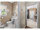 Stylish half bathroom with classic pedestal sink, decorative mirror and tiled floor at 210 Farr Lake Dr, Tyrone, GA 30290