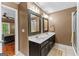 Well-lit bathroom with double vanity, framed mirrors, and neutral decor at 210 Farr Lake Dr, Tyrone, GA 30290