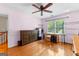 Bright bedroom featuring hardwood floors, a ceiling fan, and natural light at 210 Farr Lake Dr, Tyrone, GA 30290