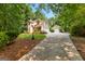 Charming two-story home with a two car garage, mature trees, and colorful flower beds at 210 Farr Lake Dr, Tyrone, GA 30290