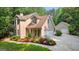 Charming two-story home with a two car garage, mature trees, and colorful flower beds at 210 Farr Lake Dr, Tyrone, GA 30290