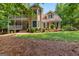 Charming two-story home with a balcony, a welcoming front entrance, and mature landscaping at 210 Farr Lake Dr, Tyrone, GA 30290