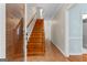 Foyer showcasing a wooden staircase, tiled floor, and natural light creating a warm and inviting entrance at 210 Farr Lake Dr, Tyrone, GA 30290