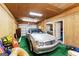 The garage showcases a silver convertible, complemented by a functional space with ample storage and a door at 210 Farr Lake Dr, Tyrone, GA 30290