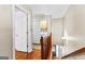 Hallway with hardwood floors and a view of the laundry room at 210 Farr Lake Dr, Tyrone, GA 30290