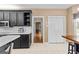 Charming kitchen with black cabinets, white countertops, and stainless steel appliances at 210 Farr Lake Dr, Tyrone, GA 30290