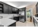 Stylish kitchen featuring black cabinets, white countertops and stainless steel appliances at 210 Farr Lake Dr, Tyrone, GA 30290