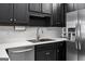 Close-up of kitchen sink with stainless steel appliances and white tile backsplash at 210 Farr Lake Dr, Tyrone, GA 30290