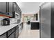 Modern kitchen showcasing black cabinets, white countertops, and tiled flooring at 210 Farr Lake Dr, Tyrone, GA 30290