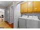 Convenient laundry room with modern washer and dryer units and storage cabinets at 210 Farr Lake Dr, Tyrone, GA 30290