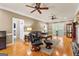 Spacious living room with hardwood floors, elegant furnishings, and a sliding door to the outdoors at 210 Farr Lake Dr, Tyrone, GA 30290