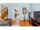 Open-concept living room with hardwood floors leads to the kitchen and staircase, offering versatile living at 210 Farr Lake Dr, Tyrone, GA 30290