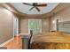 Tranquil main bedroom with hardwood floors, ceiling fan and access to walk-in closet at 210 Farr Lake Dr, Tyrone, GA 30290