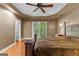 Bright main bedroom with hardwood floors, ceiling fan and double doors to balcony at 210 Farr Lake Dr, Tyrone, GA 30290