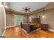 Spacious bedroom featuring hardwood floors, tray ceiling, and a private balcony at 210 Farr Lake Dr, Tyrone, GA 30290